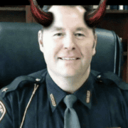 Fostoria News Police officer with devil horns filter, smiling in uniform.